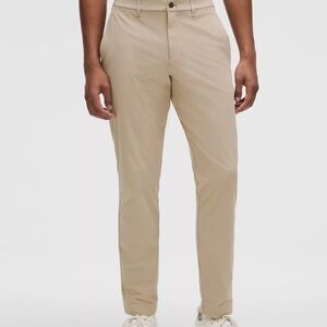 LULULEMON. NEVER USED. TAN. FLEX MATERIAL.  SLIM FIT.  35 x 28